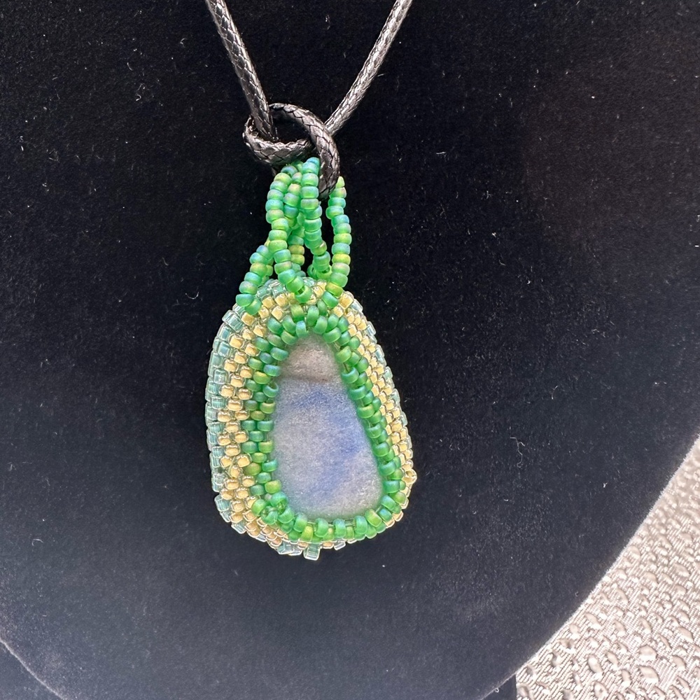 Handcrafted Larimar stone with glass beaded bezel.